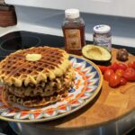 Savory Corn Waffles plated with topping ideas of honey, avocado, tomatoes or jam.